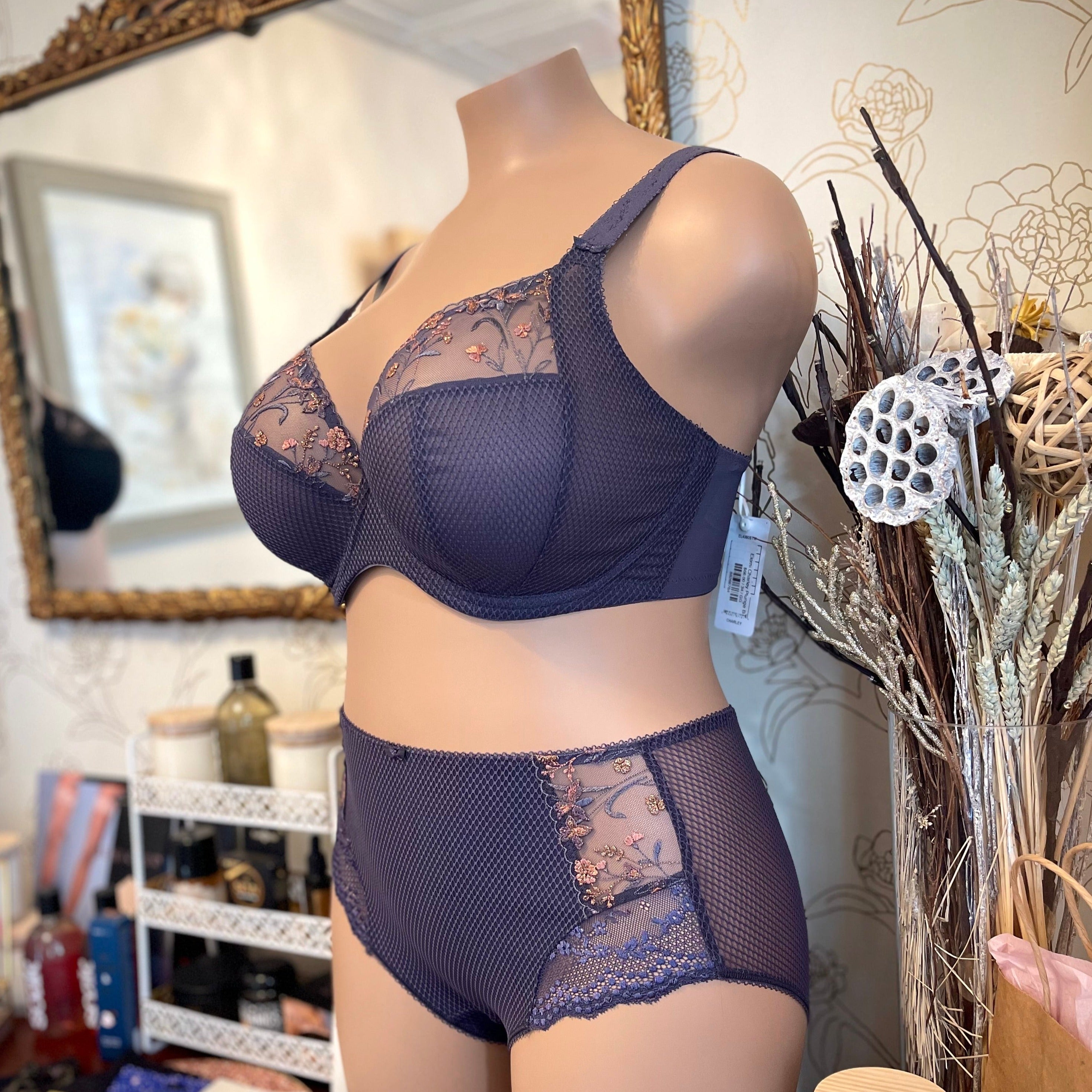 Elomi Charley Underwire Bra featuring shimmery floral embroidery and sheer mesh cups. Designed with a three-piece cup for forward-shaping lift, adjustable anti-slip straps, and a J-hook for racerback conversion. Shown in an elegant, breathable fabric ideal for everyday comfort and support.