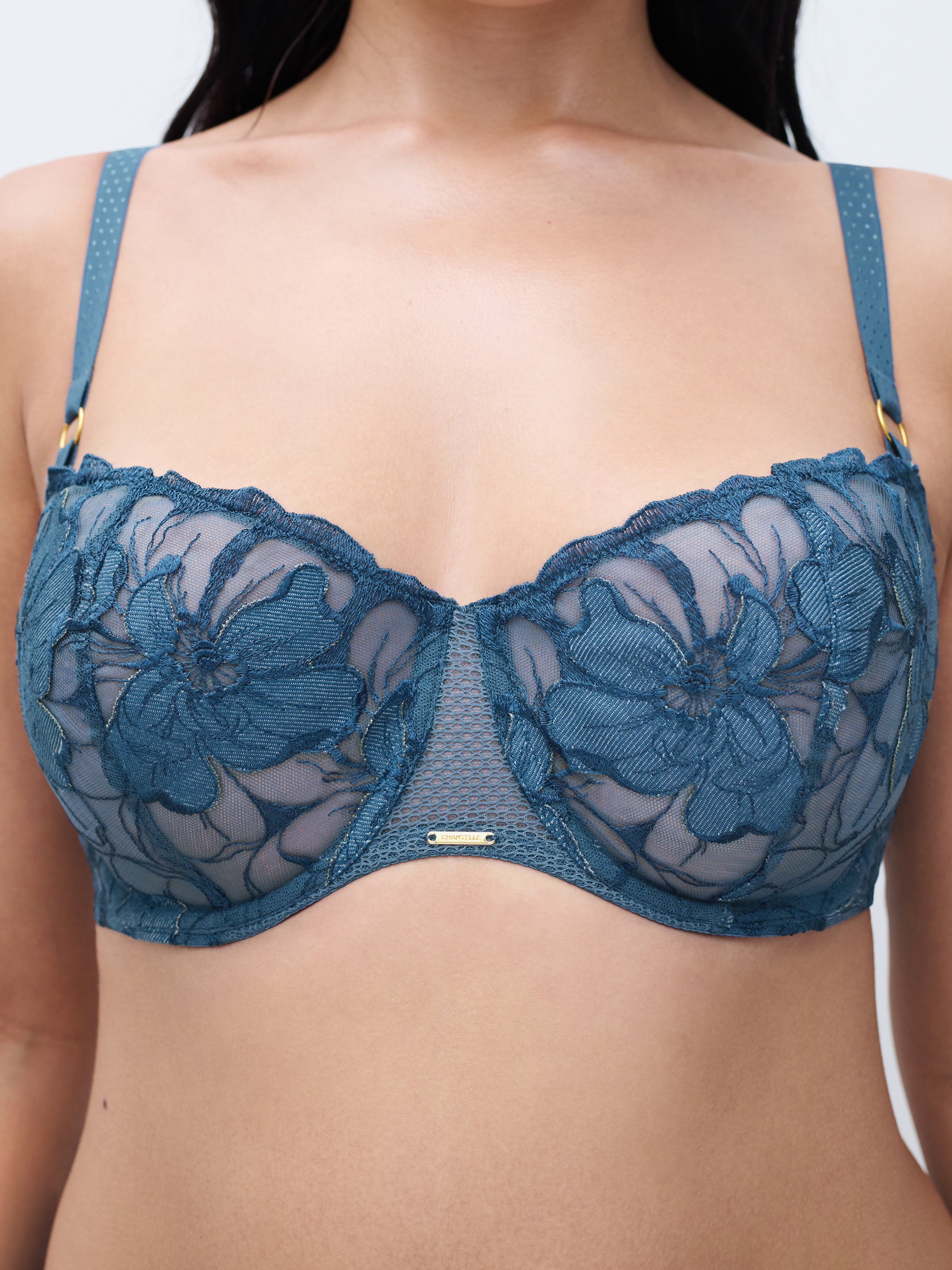 Front view of the Fleurs Signature Demi Bra in Blue Denim, showcasing delicate velvet floral embroidery on sheer mesh cups, a plunging neckline, and polka-dot straps with decorative rings.